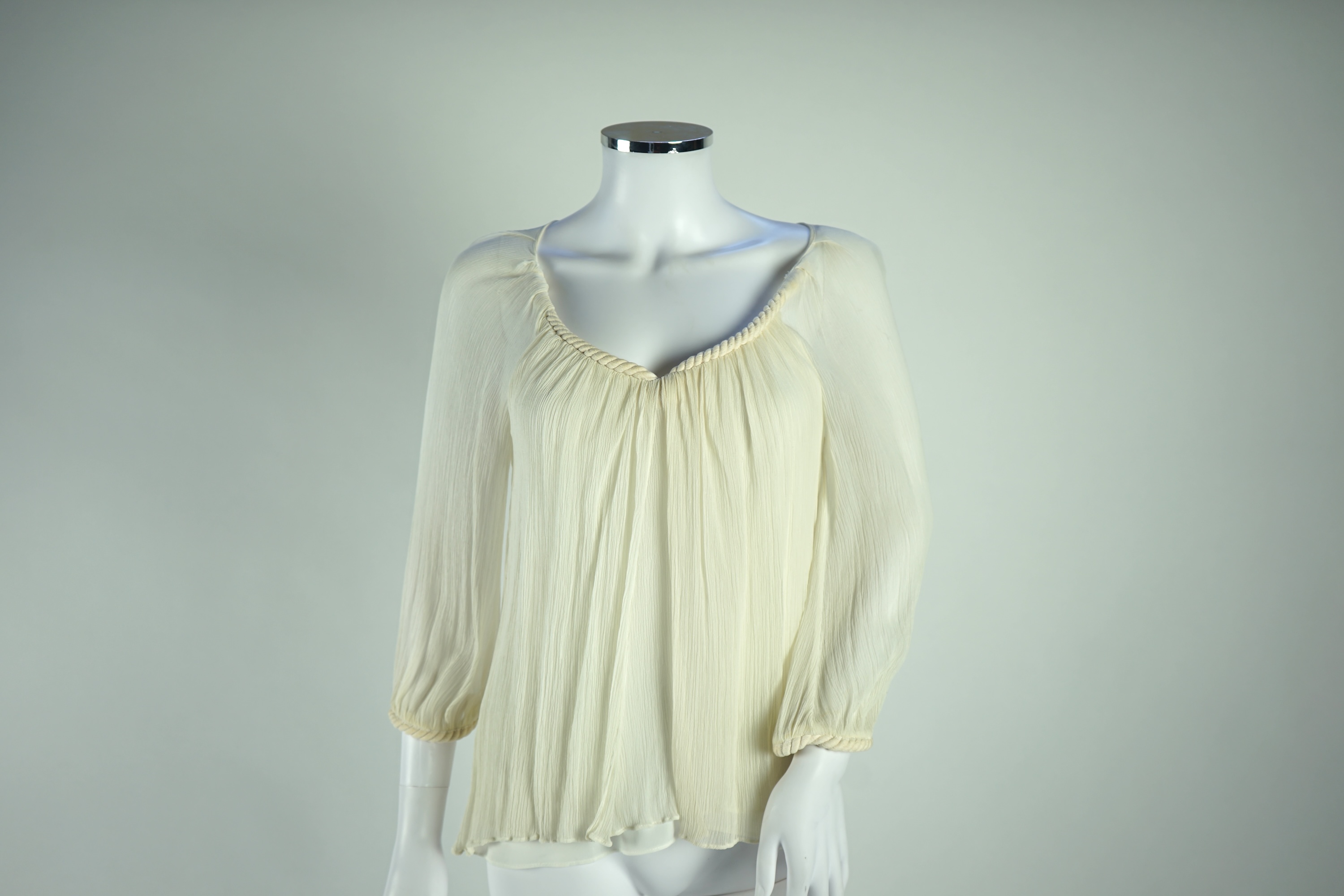 A Diane von Furstenberg cream silk lady's blouse with rope detail, a Dusk for Frank Usher cream silk waistcoat and a white cotton shirt, size 10